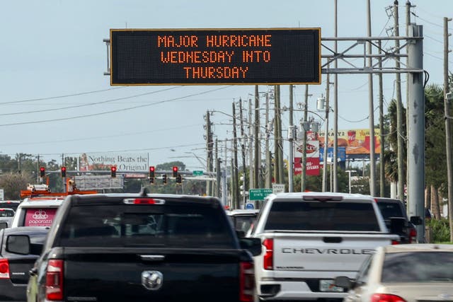 <p>Florida highway signage announces the impending arrival of Hurricane Milton in Port Richey on Tuesday. State officials told residents that the time to leave the area is now. </p>