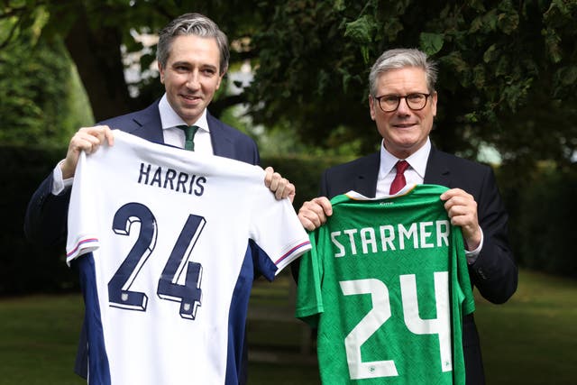 <p>Taoiseach Simon Harris (left) and prime minister Sir Keir Starmer, hold up England and Ireland football shirts at Farmleigh House, Dublin</p>
