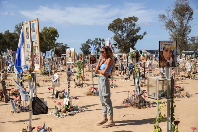 <p>A woman observes a memorial put up for the innocent people killed by Hamas on October 07 </p>
