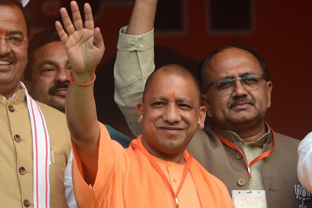 <p>Chief minister of Uttar Pradesh, Yogi Adityanath waves during a public meeting for BJP's candidate for the by poll to Phulpur (Allahabad) Lok Sabha seat in Allahabad on 8 March 2018</p>